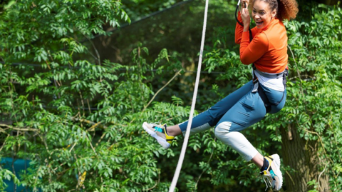 Woman on rope swing in the trees